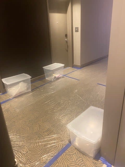 The hallway outside Mitch Beaulieu's hotel room at the federal quarantine site near the Calgary airport.  Food and supplies are left in containers outside the guest room.