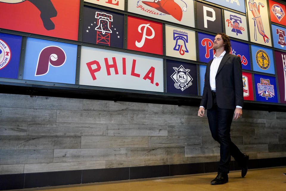 Philadelphia Phillies baseball team pitcher Aaron Nola heads to a press conference after signing a seven-year contract, Monday, Nov. 20, 2023, in Philadelphia. (AP Photo/Chris Szagola)