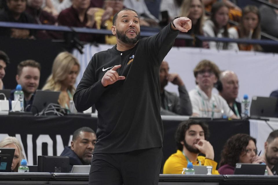 Minnesota head coach Ben Johnson points during the first half of an NCAA college basketball game against Michigan State in the second round of the Big Ten Conference tournament, Thursday, March 14, 2024, in Minneapolis. (AP Photo/Abbie Parr)