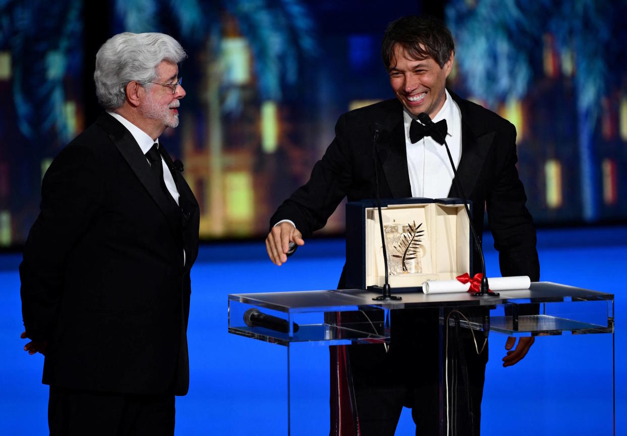 Sean Baker a reçu la Palme d’Or du 77e Festival de Cannes des mains de George Lucas qui a reçu pour sa part une Palme d’Or d’honneur.