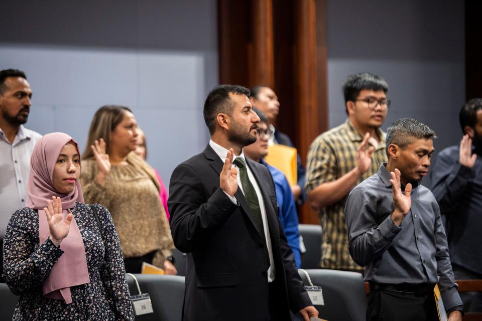 Ravand Al Dosaki takes the oath to be sworn in as a U.S. citizen in the Fred D Thompson Federal Building & Courthouse in Nashville, Tenn., Tuesday, Oct. 24, 2023.