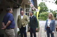 FILE Britain's Prime Minister and Conservative Party leader, Rishi Sunak, meets with conservative prospective parliamentary candidate, Jeremy Quin, second left, and Sussex police and crime commissioner, Katy Bourne, right, and Chairman of Neighbourhood Watch Sussex, John Wright, left, at the Dog and Bacon pub in Horsham, south of London, Monday June 10, 2024, ahead of a campaign event in the build-up to the UK general election on July 4. A swathe of seats in southern England, the wealthiest part of the country, where voters traditionally have supported the Conservative Party, whose traditional color is blue. (Henry Nicholls/Pool Photo via AP, File)