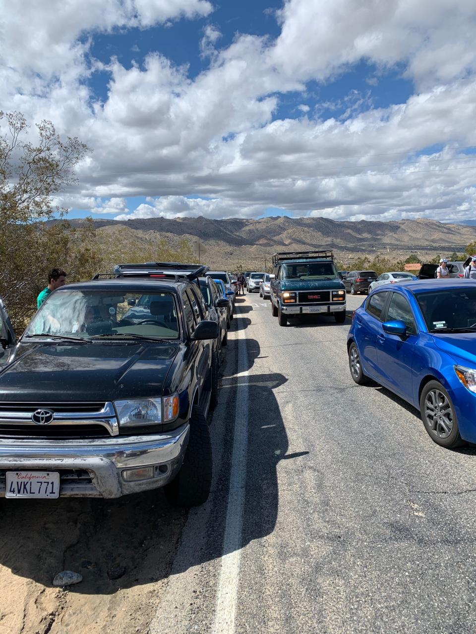 Traffic mounts at Joshua Tree National Park's West Entrance as park closes campgrounds and roads on March 22, 2020.