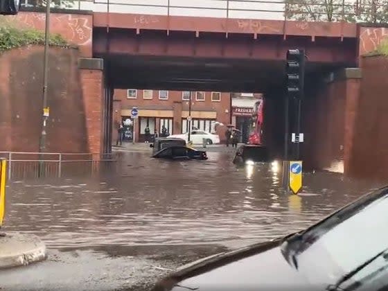 Floodwaters submerge cars in Raynes Park in Wimbledon (Twitter)