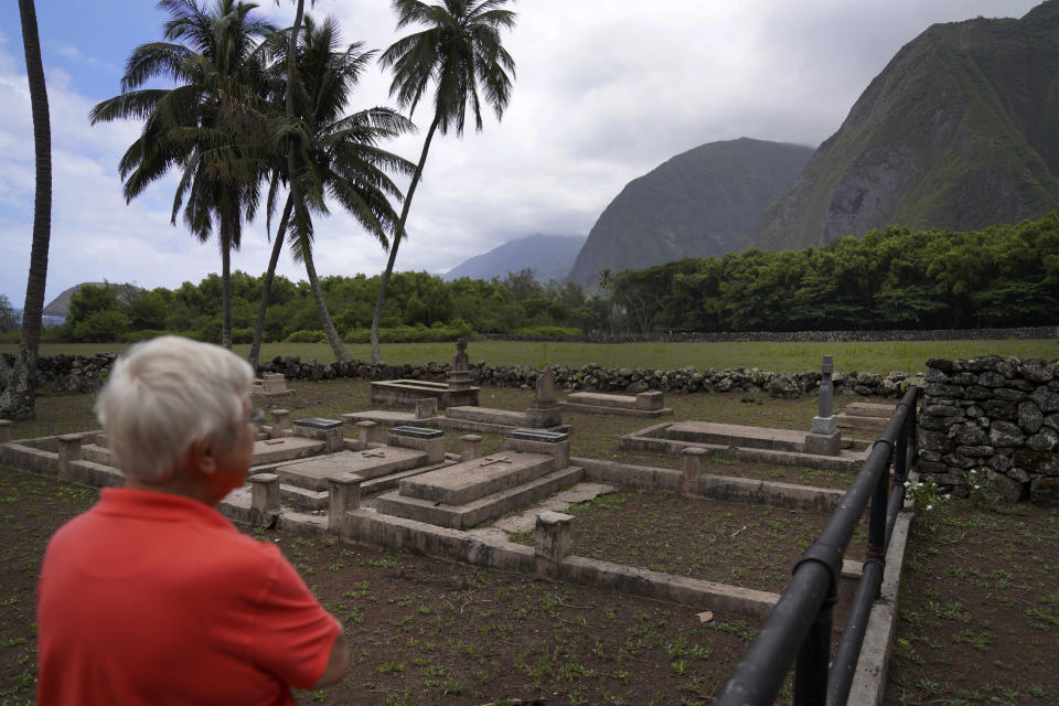 Sister Barbara Jean Wajda looks out toward the field of unmarked graves next to St. Philomena Church on Kalaupapa, Hawaii on Tuesday, July 18, 2023. More than 8,000 people, mostly Native Hawaiians, perished at Kalaupapa, including Saint Damien who eventually contracted leprosy, later called Hansen's disease. (AP Photo/Jessie Wardarski)