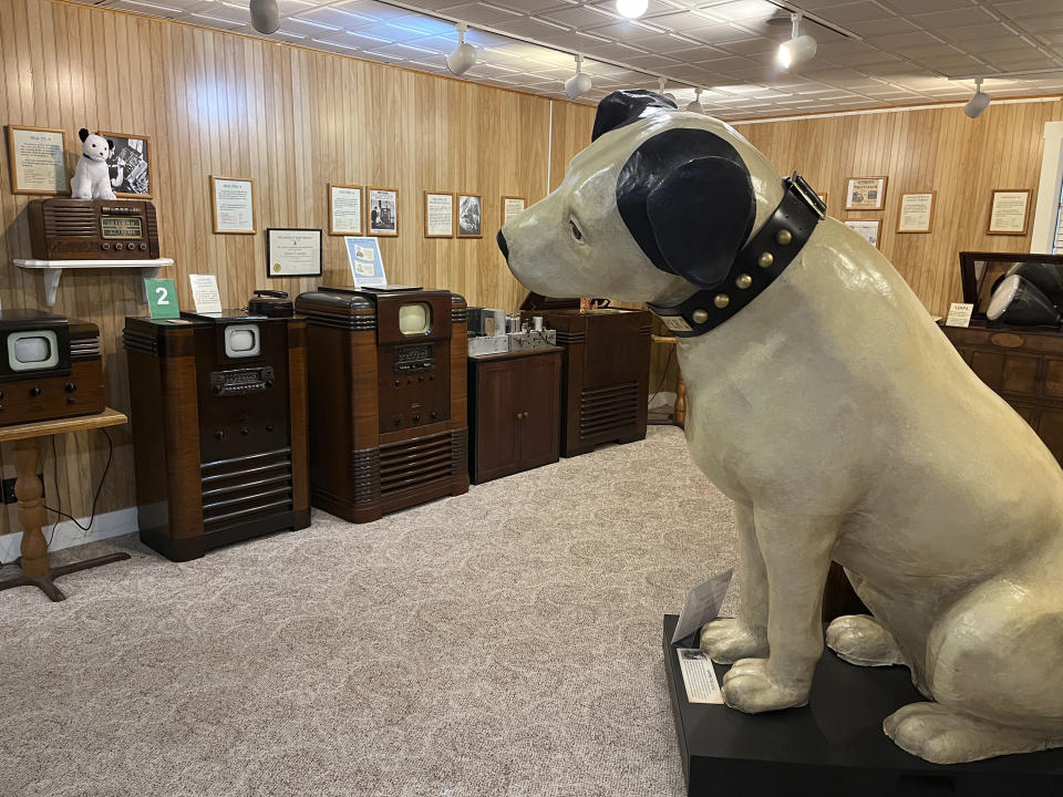 A replica of the RCA mascot Nipper appears among the collection of televisions at the Early Television Museum in Hilliard, Ohio on June 4, 2023. The museum features a large collection of televisions from the 1920s and 1930s. It also has scores of the much-improved, post-World War II, black-and-white sets that changed the entertainment landscape. (Steve Wartenberg via AP)