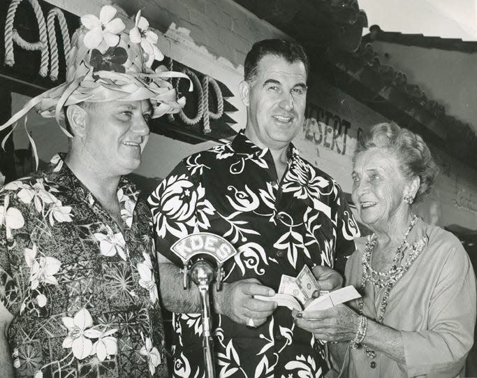 Ambassador of Aloha Waltah Clarke with Frank Bogert and philanthropist and socialite Elsinore Machris in front of Clarke's Hawaiian Shop on South Palm Canyon Drive, circa 1960.