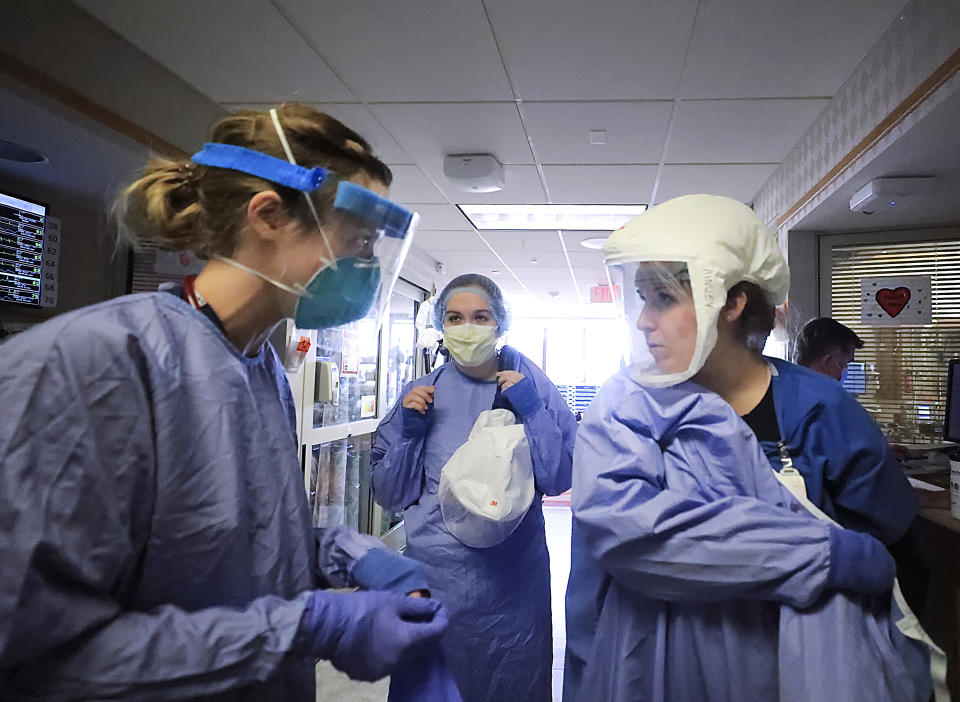 FILE - In this Nov. 5, 2020, file photo, medical staff attending to patients with COVID-19 wear protective equipment in a unit dedicated to treatment of the coronavirus at UW Health in Madison, Wis. In Wisconsin, hospitalizations dropped dramatically over the last three and a half months, from a high of 2,277 patients on Nov. 17 to 355 on Wednesday, Feb. 24, 2021, according to the Wisconsin Hospital Association. (John Hart/Wisconsin State Journal via AP, File)