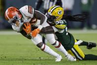 Green Bay Packers' De'Vondre Campbell stops Cleveland Browns D'Ernest Johnson during the second half of an NFL football game Saturday, Dec. 25, 2021, in Green Bay, Wis. (AP Photo/Matt Ludtke)