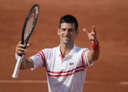 Serbia's Novak Djokovic celebrates towards the crowd after defeating Uruguay's Pablo Cuevas in their second round match on day 5, of the French Open tennis tournament at Roland Garros in Paris, France, Thursday, June 3, 2021. (AP Photo/Christophe Ena)