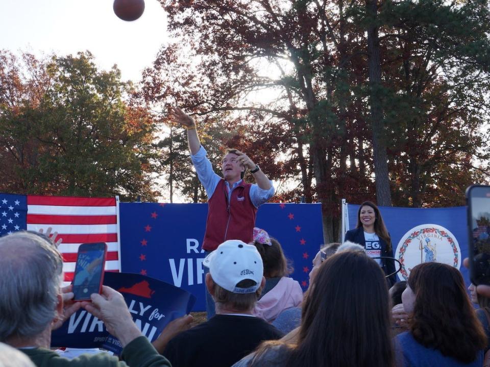 Virginia Gov. Glenn Youngkin throws a basketball into the crowd at a rally for GOP congressional candidate Yesli Vega in Spotsylvania, VA.