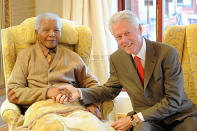 Former US President, Bill Clinton, right, meets with former South African President Nelson Mandela at his home in Qunu, South Africa, Tuesday, July 17, 2012 on the eve of Mandela's 94th birthday. (AP Photo/Peter Morey)
