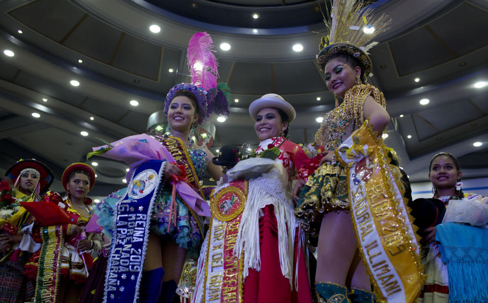 Contestants wait for the judges decision on who will be crowned Queen of Great Power, in La Paz, Bolivia, Friday, May 24, 2019. The largest religious festival in the Andes choses its queen in a tight contest to head the Festival of the Lord Jesus of the Great Power, mobilizing thousands of dancers and more than 4,000 musicians into the streets of La Paz. (AP Photo/Juan Karita)