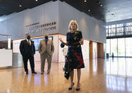 First lady Jill Biden speaks to gathered employees and media during a visit to the National Museum of African American History and Culture with Lonnie Bunch, Secretary of the Smithsonian, center, and National Museum of African American History and Culture director Kevin Young, left, Friday, May 14., 2021, in Washington. (AP Photo/Carolyn Kaster)