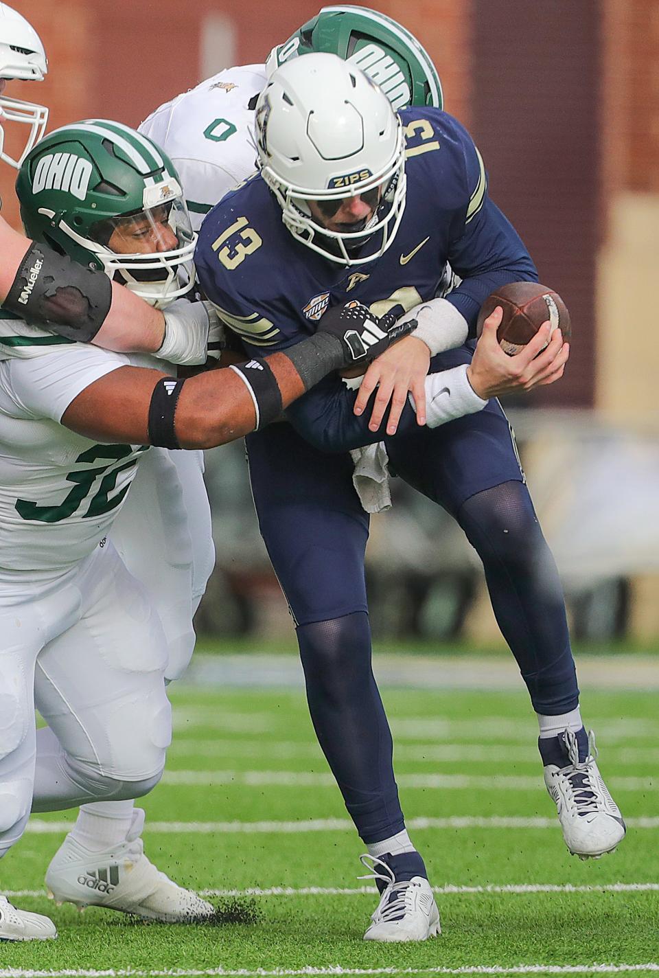 University of Akron quarterback Jeff Undercuffer, Jr. is sacked by Ohio's Ben Johnson and Rayyan Buell on Friday, Nov. 24, 2023.