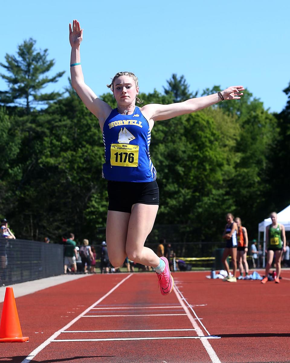 Norwell’s Lily MacDonald leaps out during the long jump during the Division 5 state tournament at the Norwell Clipper Community Complex on Saturday, May 27, 2023.