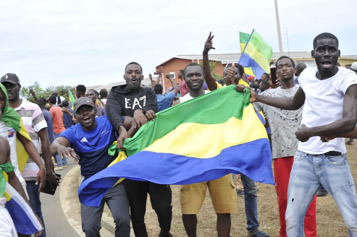 Residents in Libreville celebrate the Gabon coup on Wednesday (AFP via Getty Images)