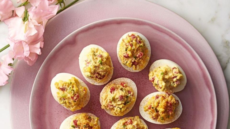 pimiento cheese deviled eggs on a pink plate