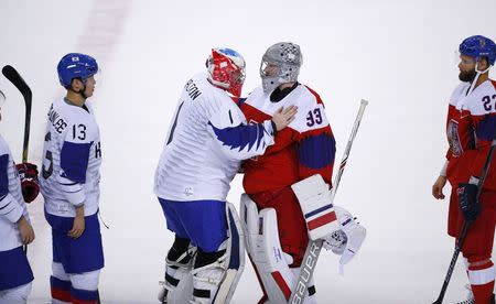 Ice Hockey – Pyeongchang 2018 Winter Olympics – Men Preliminary Round Match – Czech Republic v South Korea - Gangneung Hockey Centre, Gangneung, South Korea – February 15, 2018 - Goalies Matt Dalton of South Korea (L) and Pavel Francouz of the Czech Republic greet each other after the game. REUTERS/Brian Snyder