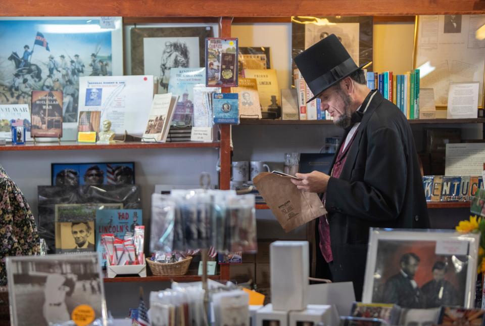 Abraham Lincoln look-alike Larry Elliott shops at the Lincoln Museum in Hodgenville, Kentucky during the  Lincoln Days celebration.  Oct, 1, 2022