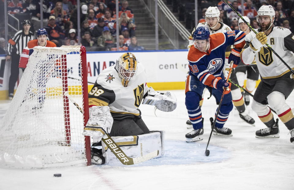 Vegas Golden Knights goalie Laurent Brossoit (39) makes a save as Edmonton Oilers' Zach Hyman (18) looks for the rebound during the second period of an NHL hockey game Saturday, March 25, 2023, in Edmonton, Alberta. (Jason Franson/The Canadian Press via AP)