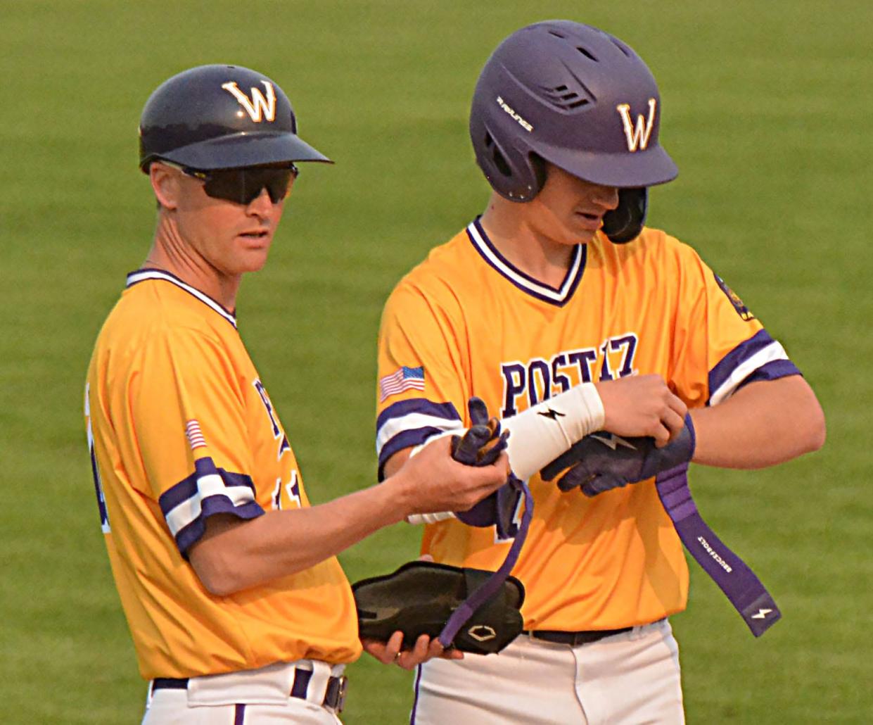 Watertown Post 17 head coach Ryan Neale gets some equipment from Treyton Himmerich after Himmerich tripled during a baseball doubleheader against West Fargo (N.D.) on Thursday, May 18, 2023 at Watertown Stadium.