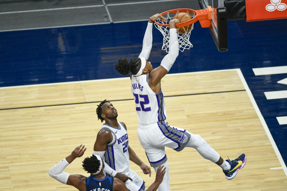 Sacramento Kings center Richaun Holmes dunks as Kings guard Buddy Hield looks on during the first half of an NBA basketball game against the Minnesota Timberwolves, Monday, April 5, 2021, in Minneapolis. (AP Photo/Craig Lassig)