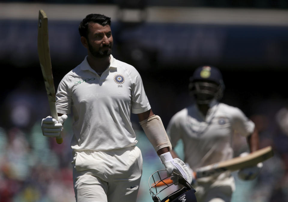 India's Cheteshwar Pujara waves his bat as walks off after he was caught out for 193 runs against Australia on day 2 during their cricket test match in Sydney, Friday, Jan. 4, 2019. (AP Photo/Rick Rycroft)