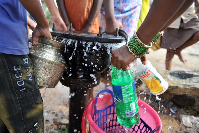 Indian women fill containers with drinking water from a leaking water pipe on the outskirts of Hyderabad on May 13, 2011. Nearly two thirds of people in the Asia-Pacific region have no clean, piped water at home despite the region's strong economic growth, according to a major report released on Wednesday