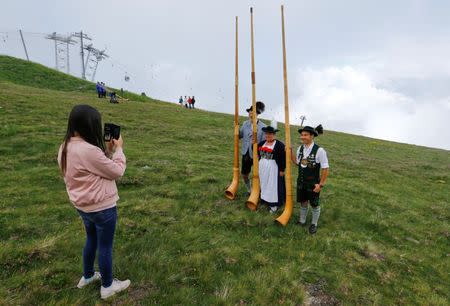 Alphorn blowers pose for a photo on the last day of the Alphorn International Festival on the alp of Tracouet in Nendaz, southern Switzerland, July 22, 2018. REUTERS/Denis Balibouse