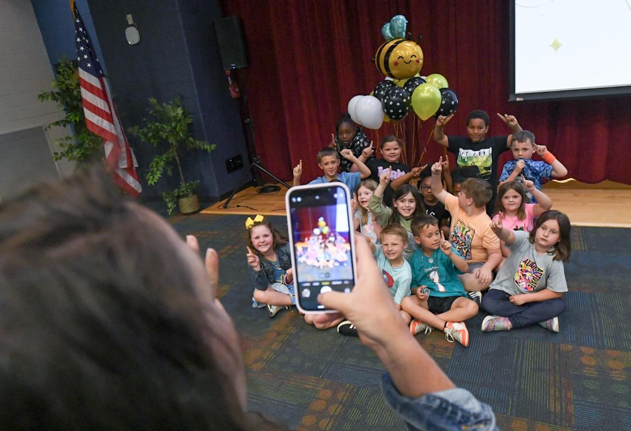 Second grade students pose for a photo with their teacher Kellie Martin after North Pointe Elementary was named as one of the 2023-24 Palmetto's Finest schools, during the announcement in the school auditorium.