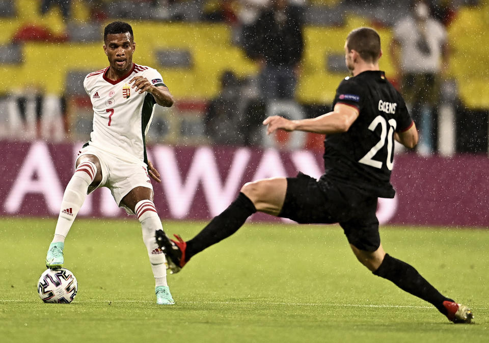 Hungary's Loic Nego, left, and Germany's Robin Gosens challenge for the ball during the Euro 2020 soccer championship group F match between Germany and Hungary at the Allianz Arena in Munich, Germany,Wednesday, June 23, 2021. (Lukas Barth/Pool Photo via AP)