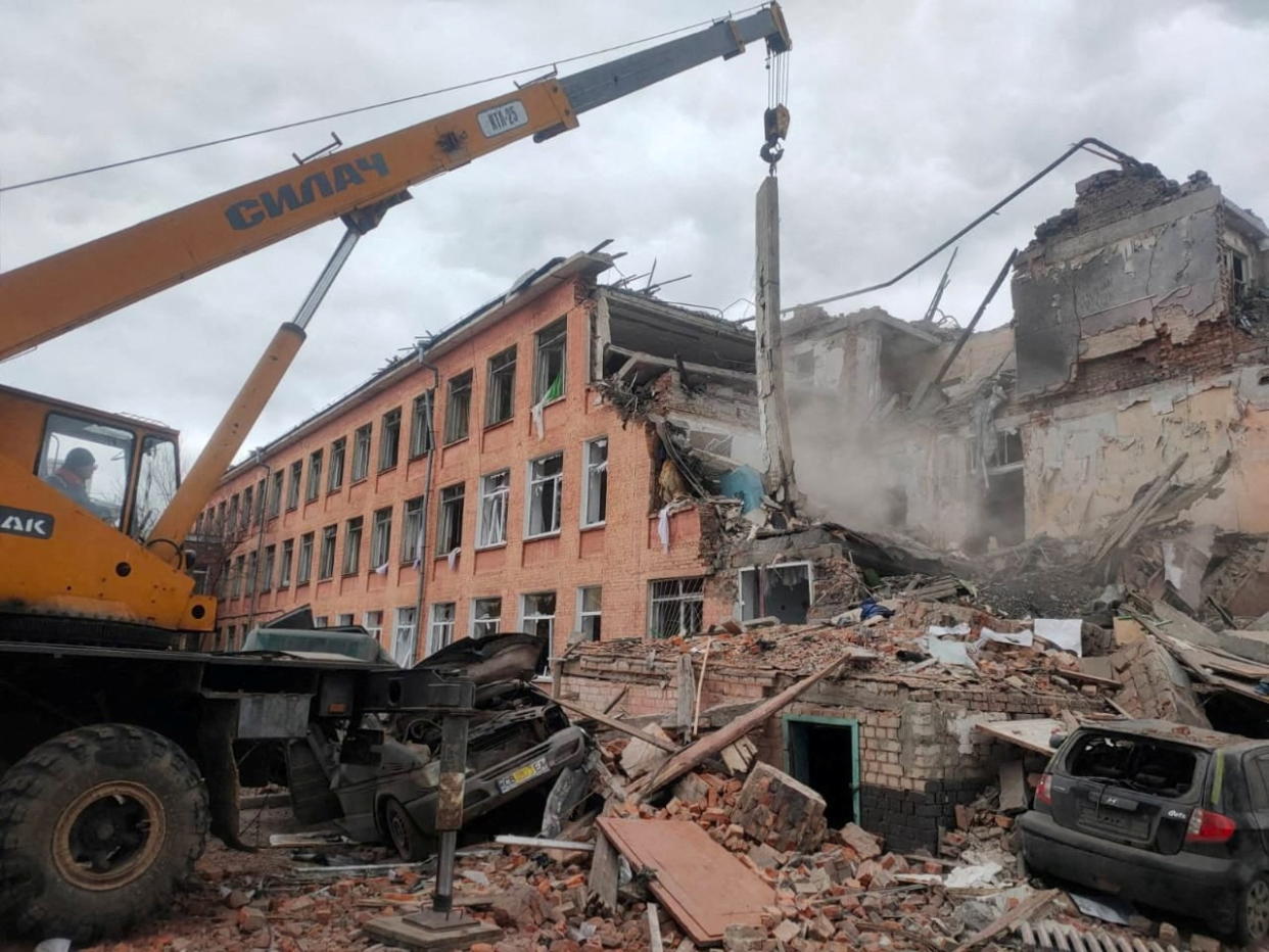 Rescuers remove debris from a school building damaged by shelling, amid the Russian invasion of Ukraine, in Chernihiv, Ukraine, in this handout picture released March 7, 2022.  Press service of the State Emergency Service of Ukraine/Handout via REUTERS ATTENTION EDITORS - THIS IMAGE HAS BEEN SUPPLIED BY A THIRD PARTY. MANDATORY CREDIT