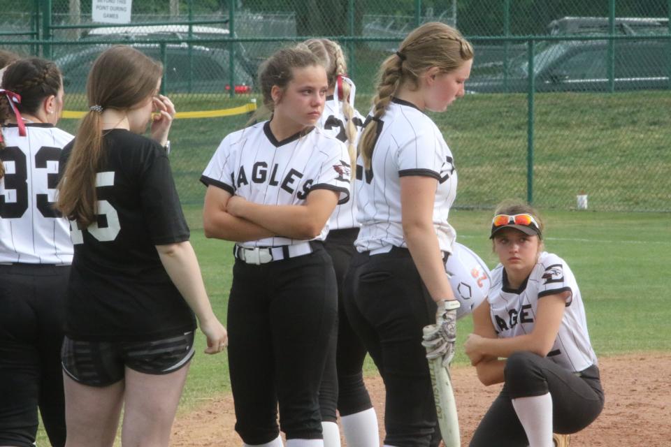 Eagleville players stand in the infield after collecting themselves minutes after assistant coach Tommy Bain collapsed on the field near third base during their Class A state softball tournament game against Huntland Friday, May 27, 2022 at Starplex in Murfreesboro, Tennessee.