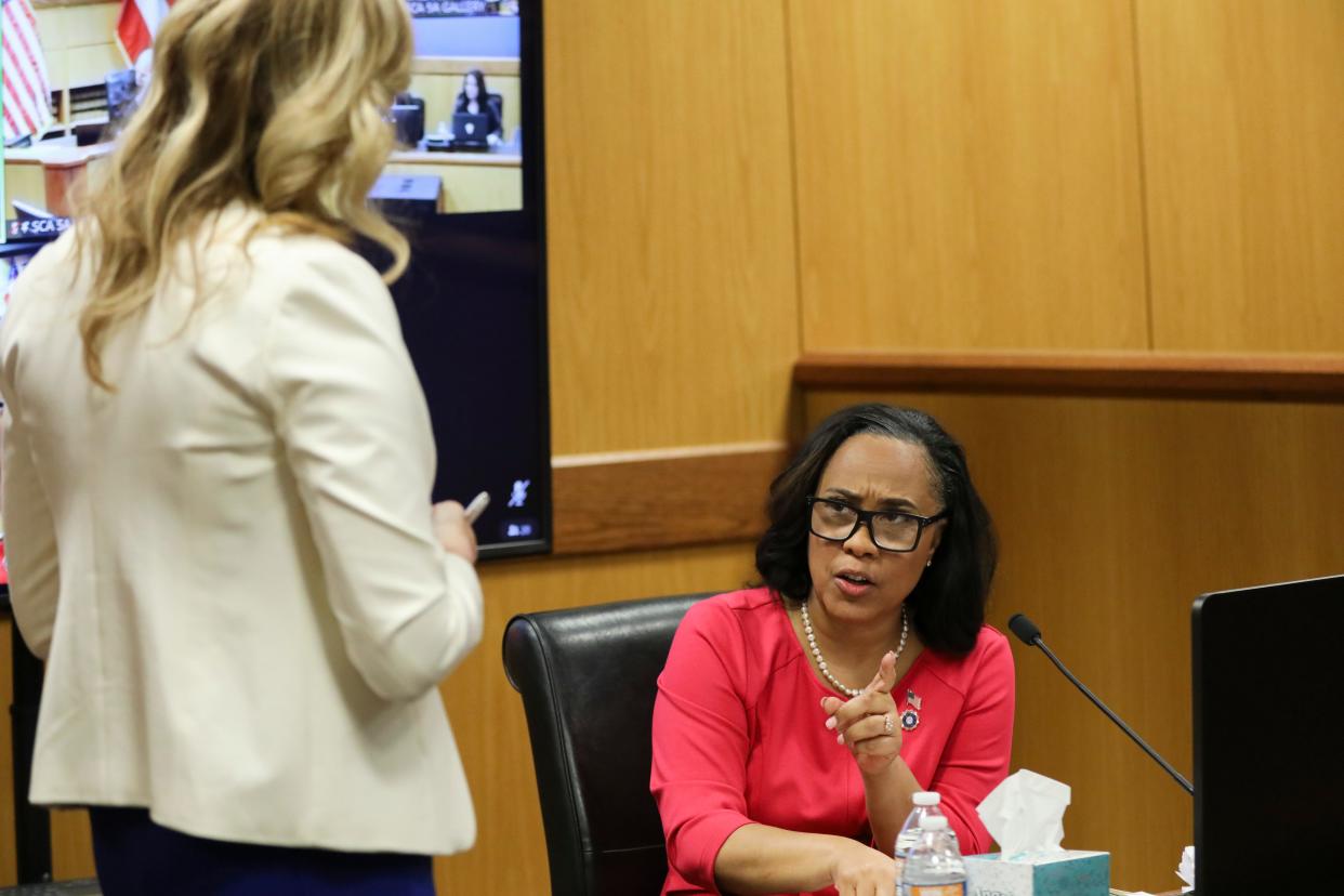 Attorney Fani Willis speaks while holding documents during a hearing in the case of State of Georgia v. Donald John Trump at the Fulton County Courthouse in Atlanta, Georgia, U.S., February 15, 2024.