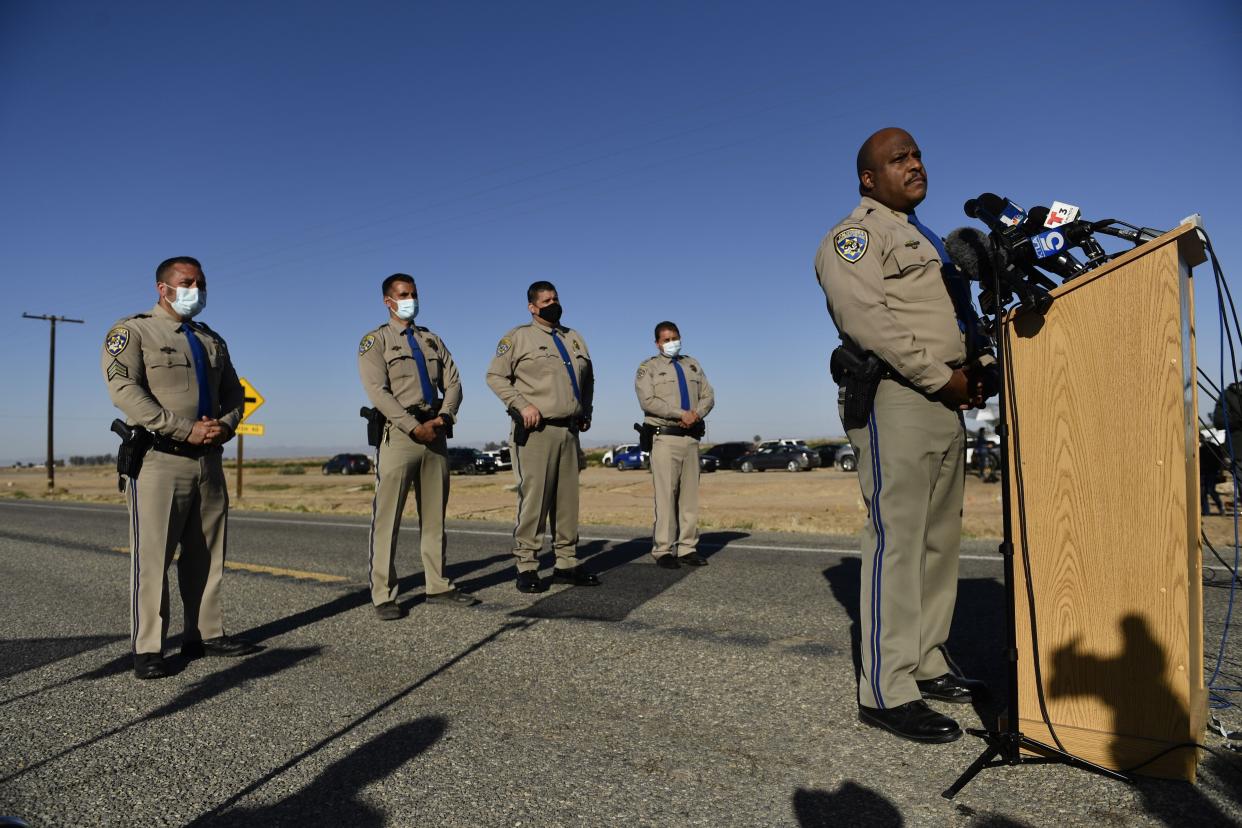 Chief Omar Watson (R) of the California Highway Patrol Border Division speaks during a press conference near the scene of a crash between an SUV and a semi-truck full of gravel near Holtville, Calif. on March 2, 2021.