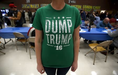 A voter wears a "Dump Trump '16" shirt at a Democratic U.S. presidential caucus in Salt Lake City, Utah March 22, 2016. REUTERS/Jim Urquhart