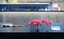 Flowers and a picture are placed in the wall at the 9/11 Memorial during a ceremony marking the 12th Anniversary of the attacks on the World Trade Center in New York September 11, 2013. (REUTERS/David Handschuh)