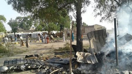 People walk at the site after a bombing attack of an internally displaced persons camp in Rann, Nigeria January 17, 2017. MSF/Handout via Reuters