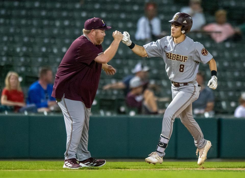 Brebeuf Jesuit Preparatory junior Jayden Ohmer (8) rounds third base after hitting a home run during a Marion County Baseball Tournament championship game against Lawrence North High School, Tuesday, May 10, 2022, at Victory Field, in Indianapolis. Brebeuf won 13-3.