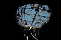 <p>A man walks next to a hole made by a Saudi-led airstrike on a destroyed funeral hall, two days after targeted it, in Sanaa, Yemen, Monday, Oct. 10, 2016. (AP Photo/Hani Mohammed)</p>