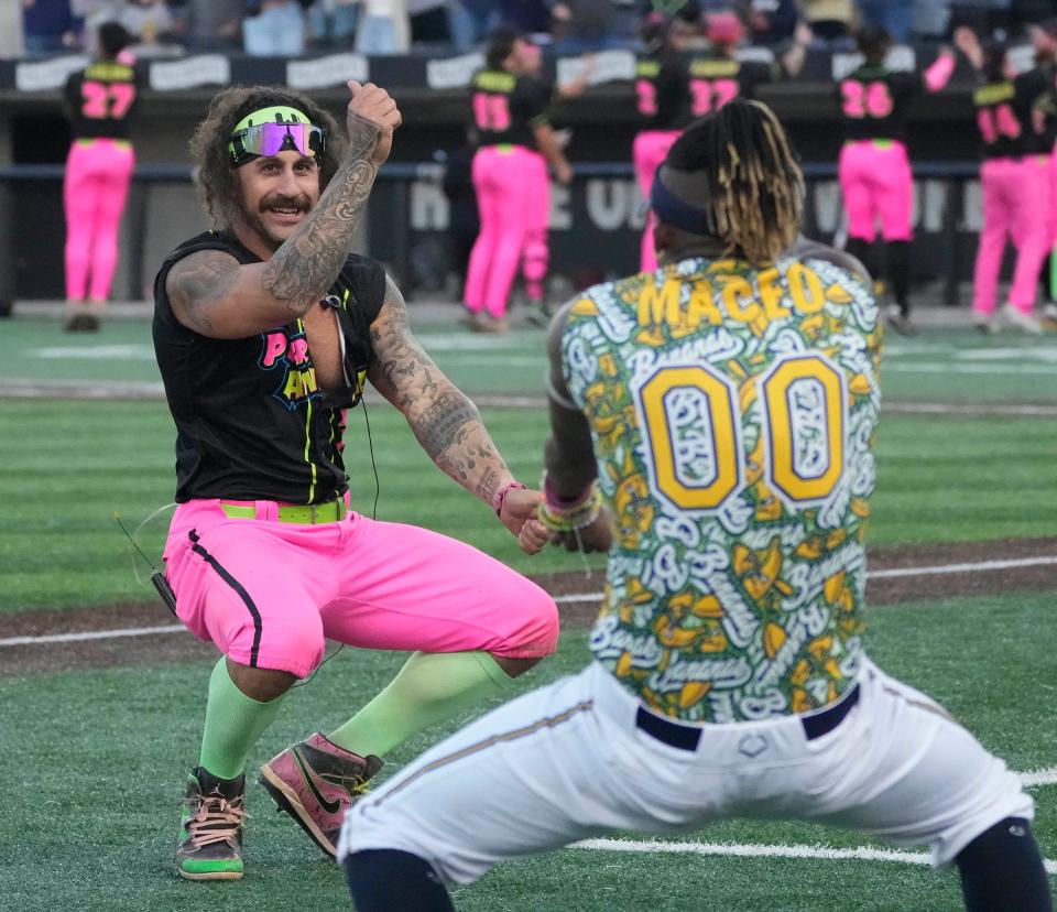 The Party Animals Jake Skole and Savannah Bananas Maceo Harrison do a dance during the exhibition baseball game against the at Franklin Field in Franklin on Friday, Sept. 8, 2023.