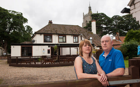 Peter and Sonia Freeman outside the pub they own - Credit: Tony Buckingham