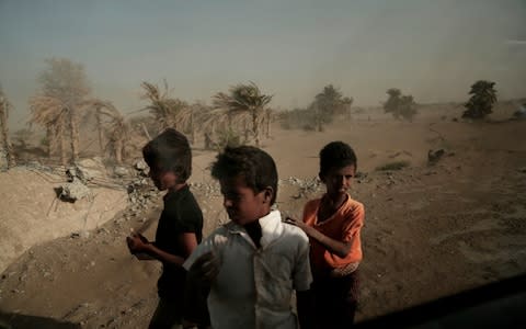 Homeless children stand on the road from Khoukha to Taiz in Yemen - Credit: AP