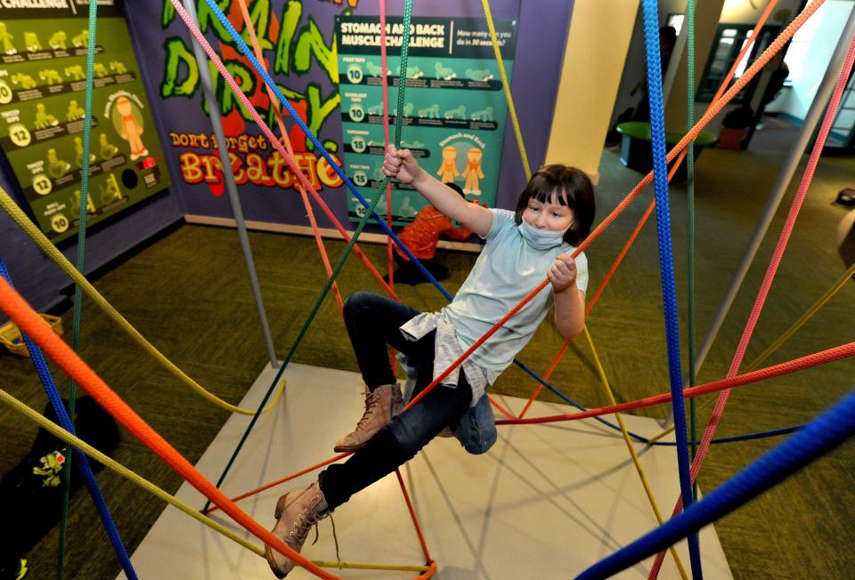 Lindsay Elementary School second grader Kira Seng, 8, climbs on ropes in a fitness room at the Kidzeum of Health and Science in Springfield Tuesday March 15, 2022. [Thomas J. Turney/The State Journal-Register]