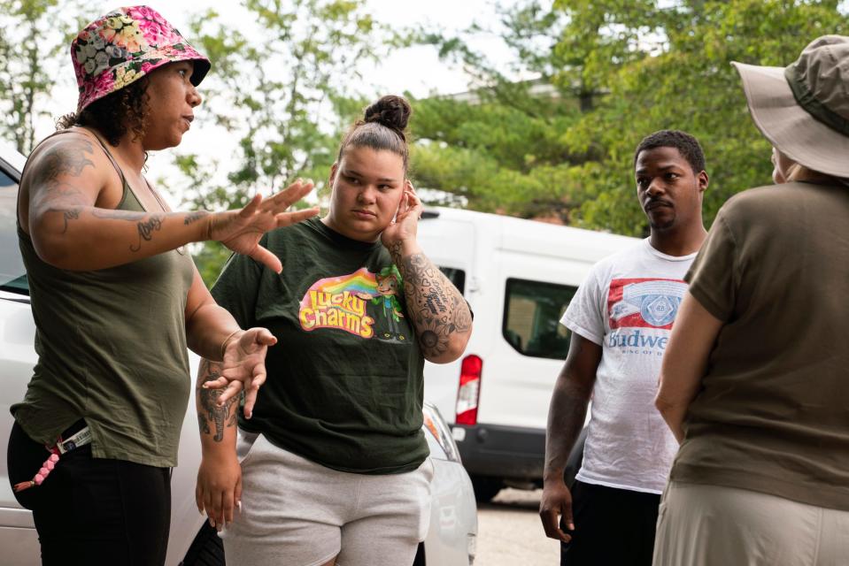 Lansing residents Synquiss Antes, 31, left, Mackenzie Winton, 27, and Emanuel Winton, 32, talk with volunteers about areas they plan to canvass before departing to search for missing toddler Wynter Cole Smith, 2, outside of the Lathrup Village Police Department on Wednesday, July 5, 2023. Smith was kidnapped from her Lansing home on July 2.