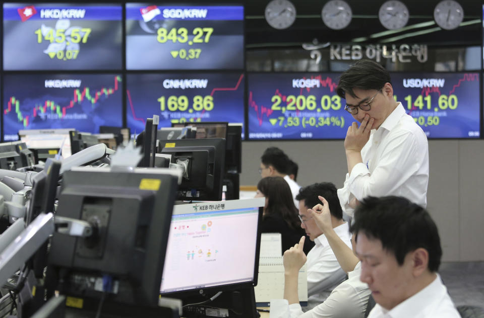 Currency traders work at the foreign exchange dealing room of the KEB Hana Bank headquarters in Seoul, South Korea, Wednesday, April 10, 2019. Asian shares fell Wednesday following a slide on Wall Street amid growing tensions between the U.S. and the European Union and a dim forecast on global economic growth.(AP Photo/Ahn Young-joon)