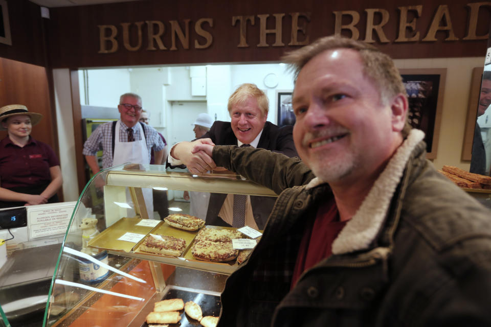 Britain's Prime Minister Boris Johnson visits a bakery during a General Election campaign trail stop in Wells, England, Thursday, Nov. 14, 2019. Britain goes to the polls on Dec. 12. (AP Photo/Frank Augstein, Pool)