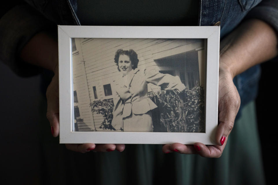 Stacy Cordova, whose aunt was a victim of California's forced sterilization program that began in 1909, holds a framed photo of her aunt Mary Franco, Monday, July 5, 2021, in Azusa, Calif. Franco was sterilized when she was 13 in 1934. Franco has since died, but Cordova has been advocating for reparations on her behalf. (AP Photo/Jae C. Hong)