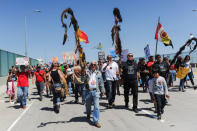 Demonstrators walk on the Pacific Coast highway during People's Climate March protest for the environment in the Wilmington neighborhood in Los Angeles, California, U.S. April 29, 2017. REUTERS/Andrew Cullen